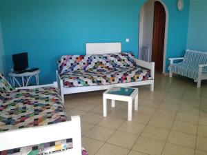 a living room with a couch and a table at Vegera Apartments in Vasilikiádhes
