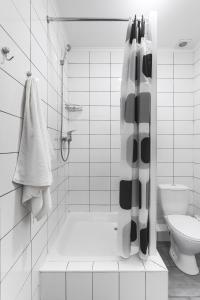 a white bathroom with a shower and a toilet at SeaZone in Zatoka