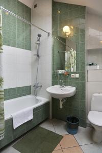 a bathroom with a sink and a tub and a toilet at Bernardinu B&B House in Vilnius +52 photos