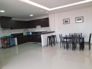 a kitchen with chairs and a table in a room at Entire flat 3rd floor in Lasip Chico