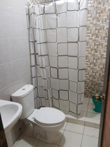 a bathroom with a toilet and a sink and a shower at Entire flat 3rd floor in Lasip Chico