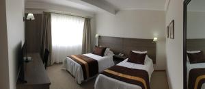 Postel nebo postele na pokoji v ubytování Conrado Hotel Osorno