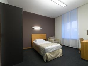 Postel nebo postele na pokoji v ubytování Hotel-Résidence Am Klouschter