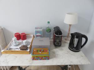 a table with a coffee maker and a coffeemaker at Chambres d'hôtes - B&B in Gétigné