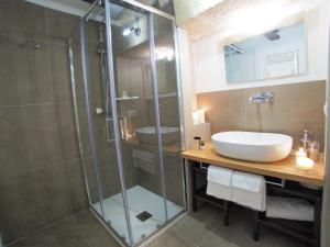 
a bathroom with a shower, sink, and toilet at Ai Sassi di Pietro in Matera
