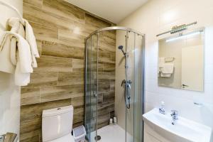 a bathroom with a shower and a toilet and a sink at Riga Airport Jurmala apartments in Rīga +47 photos