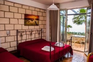 Postel nebo postele na pokoji v ubytování CapoSperone Resort