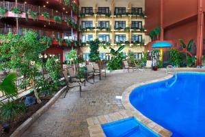 a hotel with a swimming pool in front of a building at Hotel Ambassadeur et Suites in Quebec City