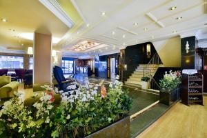 a lobby with a bunch of flowers in a building at Hotel Grand Emin in Istanbul