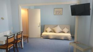 a room with a bed and a table and chairs at Logis Hotel Le Parc in Moulins