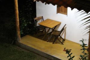 a table and chairs sitting on the porch of a house at Family Guest House in Ilha de Boipeba