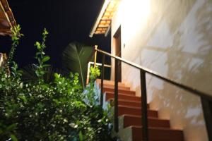 a set of stairs leading up to a house at night at Family Guest House in Ilha de Boipeba