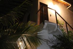 a staircase leading to a house with a door and a plant at Family Guest House in Ilha de Boipeba