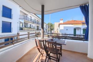 a balcony with a table and chairs and a view at Apartamentos Llafranc Mar in Llafranc