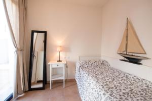 a bedroom with a bed and a dresser at Apartamentos Llafranc Mar in Llafranc