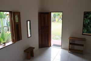 an empty room with a door and a bench in it at Family Guest House in Ilha de Boipeba