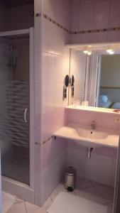 a bathroom with a sink and a mirror at Logis Hotel Le Parc in Moulins +45 photos