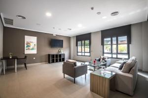 Televízia a/alebo spoločenská miestnosť v ubytovaní Apartamentos Santa Clara
