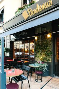 a restaurant with tables and chairs in front of a store at Locanda Pandenus Brera in Milan