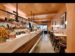 a restaurant with a bar and some tables and chairs at Locanda Pandenus Brera in Milan