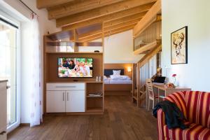 a room with a bunk bed and a tv in a room at Hotel Bellevue in Riezlern