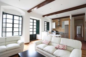 a living room with two white couches and a table at Casa Pedrosa in Mondoñedo