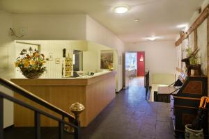 a hallway with a kitchen and a counter in a house at Hotel Hirschen in Zürich