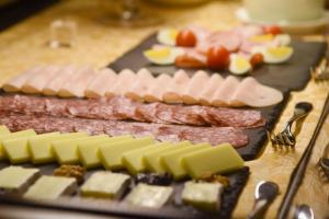 a bunch of meats and cheese on a table at Hotel Hirschen in Zürich