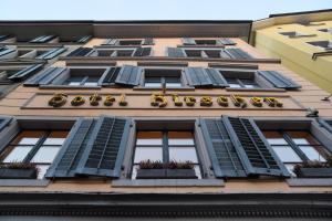 a tall building with windows and shutters on it at Hotel Hirschen in Zürich
