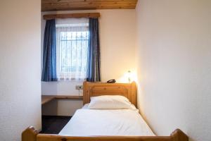 Postel nebo postele na pokoji v ubytování Garni Hotel Berc