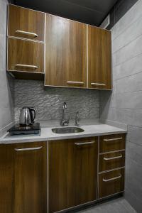 A kitchen or kitchenette at Orient Queen Homes Hotel