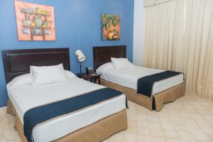 Katil atau katil-katil dalam bilik di Hotel Presidente Las Tablas