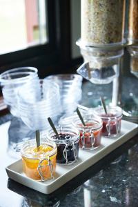 a tray with several jars of food on a table at Hotel Surte in Surte