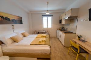 a bedroom with a large bed and a kitchen at Central Apartments with Parking in Ljubljana