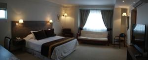 Postel nebo postele na pokoji v ubytování Conrado Hotel Osorno