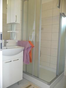 a bathroom with a shower and a sink at Apartments Milka in Umag