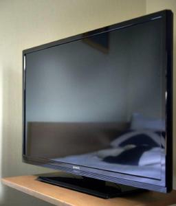 a flat screen tv sitting on a shelf at Hotel Surte in Surte