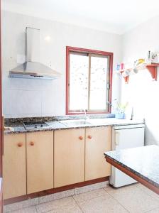 a kitchen with a sink and a stove top oven at Apartamentos Los Volcanes in Fuencaliente de la Palma