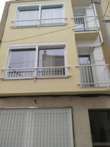 a building with balconies on the side of it at Apartamentos Bcntourism in Pineda de Mar