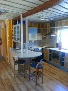 a kitchen with a table and some chairs in it at Rannapera in Peraküla