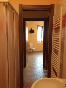 a view of a bathroom with a toilet and a hallway at Appartamento Riva in Neive