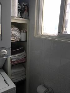 a bathroom with a towel shelf and a window at SWEET Suite BAKER Street in San Francisco