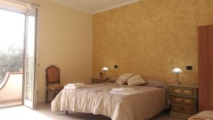 a bedroom with a bed with towels on it at Edelweiss in Palmi