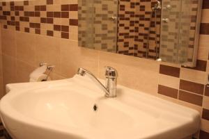 a white sink in a bathroom with a mirror at Apartment in city center in Rijeka +30 photos