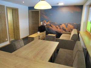 a conference room with a mountain mural on the wall at Aparthotel Garni Schranz in Wald im Pinzgau