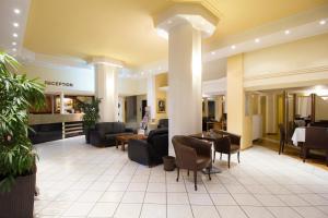 a lobby of a hotel with couches and chairs at Hotel Lithaion in Tríkala