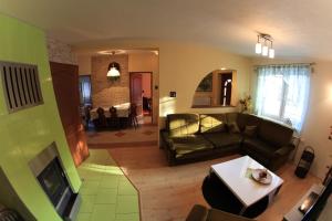 a living room with a couch and a table at Apartmanovy dom Cottage in Liptovský Ján
