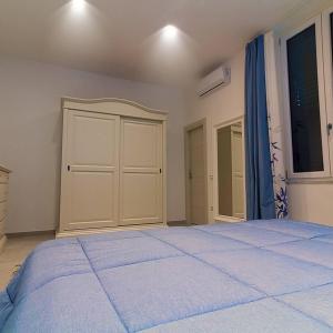 a bedroom with a large bed and a closet at Kallion house in Vietri sul Mare