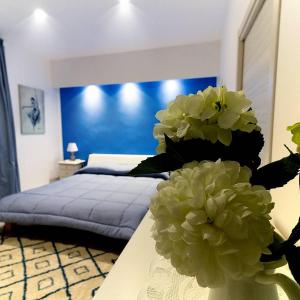 a bedroom with a bed and a table with flowers at Kallion house in Vietri sul Mare