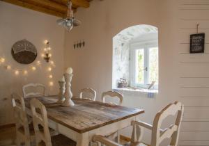 a dining room with a wooden table and chairs at Anapama in Fiskardho +17 photos